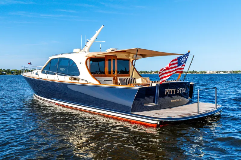 Pitt Stop Yacht Photos Pics 2020 Palm Beach Motor Yachts PB55 on water, displaying American flag, sunny day.