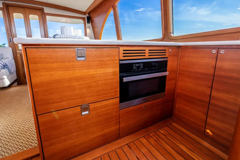 Pitt Stop Yacht Photos Pics 2020 Palm Beach Motor Yachts PB55 interior with wooden cabinetry and modern oven.