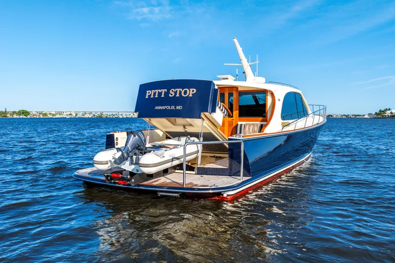 Pitt Stop Yacht Photos Pics 2020 Palm Beach Motor Yachts PB55 on water, rear view, sunny day, "Pitt Stop" name visible.