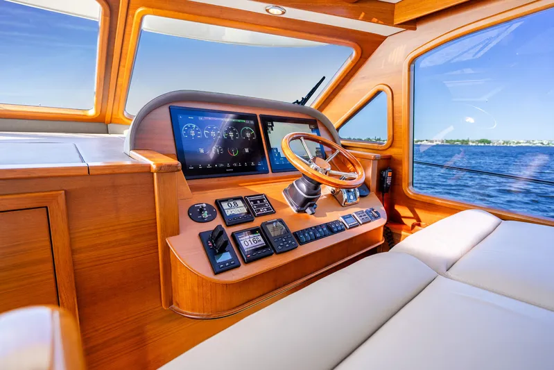Pitt Stop Yacht Photos Pics Luxurious 2020 Palm Beach Motor Yachts PB55 helm with wooden accents and modern navigation displays.