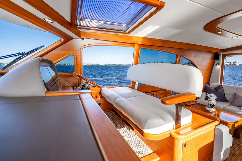 Pitt Stop Yacht Photos Pics Luxurious interior of 2020 Palm Beach Motor Yachts PB55 with elegant wood finish and waterfront view.