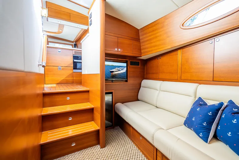 Pitt Stop Yacht Photos Pics Luxurious 2020 Palm Beach Motor Yachts PB55 interior with wooden finish and comfortable seating.