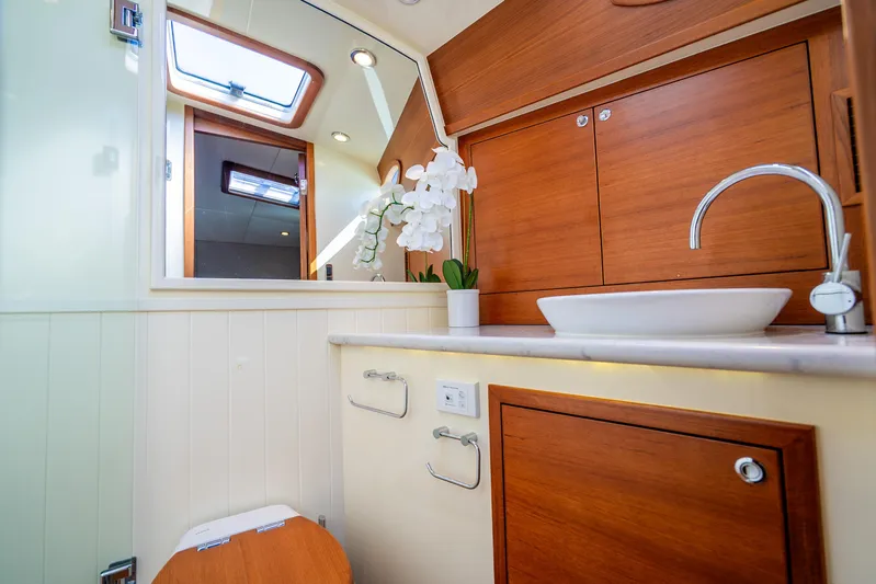 Pitt Stop Yacht Photos Pics Luxurious bathroom in 2020 Palm Beach Motor Yachts PB55, featuring elegant wood cabinetry and modern fixtures.