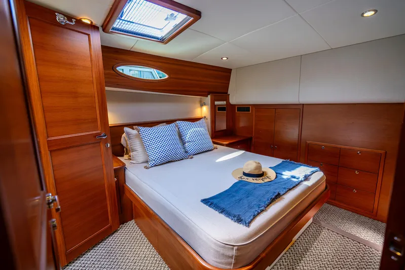 Pitt Stop Yacht Photos Pics Luxurious cabin interior of 2020 Palm Beach Motor Yachts PB55, featuring elegant wood finishes.