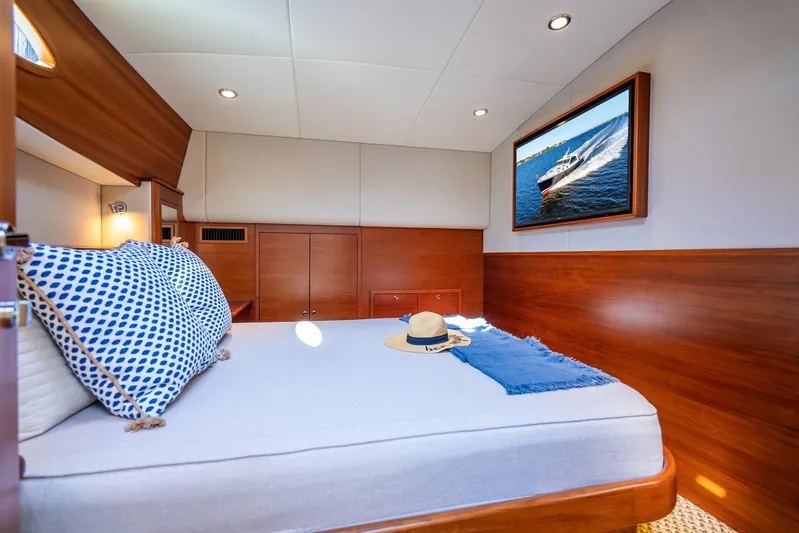 Pitt Stop Yacht Photos Pics Luxurious 2020 Palm Beach Motor Yachts PB55 cabin with elegant wood finish and cozy bedding.