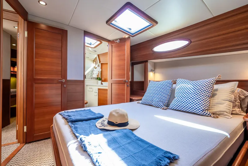 Pitt Stop Yacht Photos Pics Luxurious cabin interior of 2020 Palm Beach Motor Yachts PB55 with elegant wood finish.