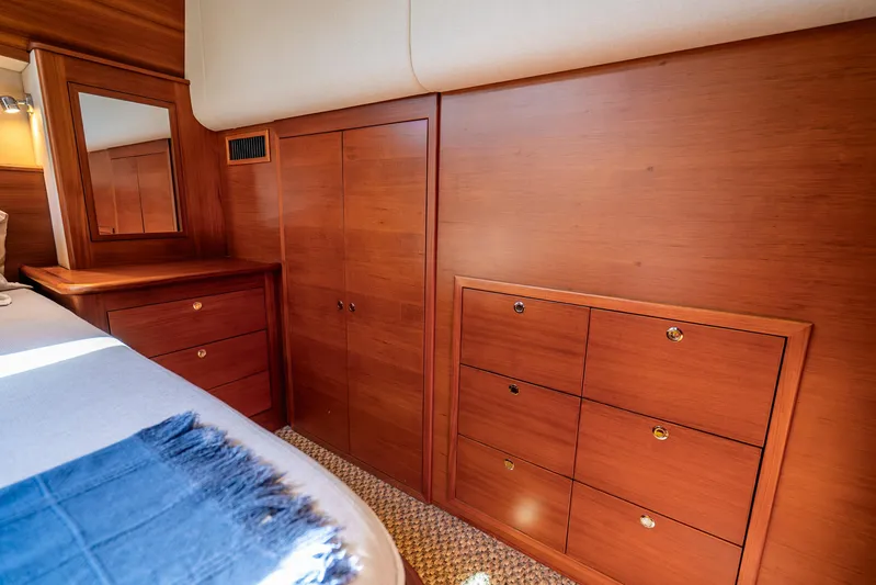 Pitt Stop Yacht Photos Pics Luxurious wooden interior of 2020 Palm Beach Motor Yachts PB55, featuring elegant cabinetry and mirror.