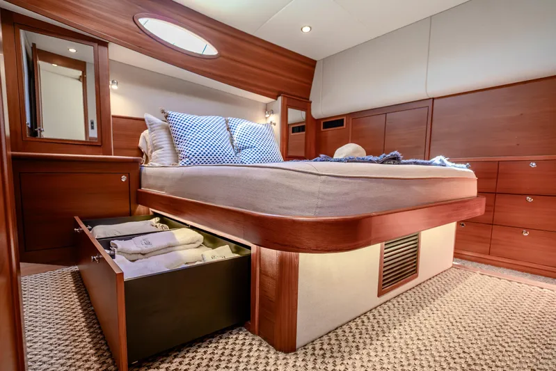 Pitt Stop Yacht Photos Pics Luxurious 2020 Palm Beach Motor Yachts PB55 bedroom with elegant wood finish and under-bed storage.