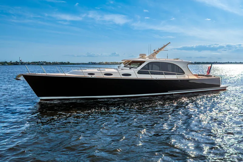 Pitt Stop Yacht Photos Pics 2020 Palm Beach Motor Yachts PB55 cruising on a sunny day, reflecting on the water.
