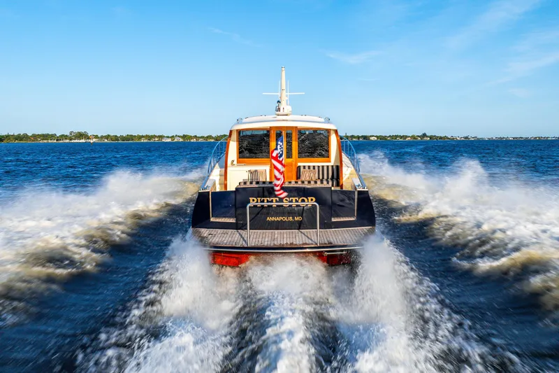 Pitt Stop Yacht Photos Pics 2020 Palm Beach Motor Yachts PB55 cruising on open water, rear view.