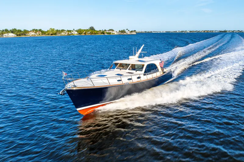 Pitt Stop Yacht Photos Pics 2020 Palm Beach Motor Yachts PB55 cruising on open water, creating a dynamic wake.