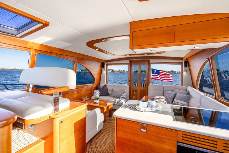 Pitt Stop Yacht Photos Pics Luxurious interior of 2020 Palm Beach Motor Yachts PB55 with elegant wood finish and scenic water view.