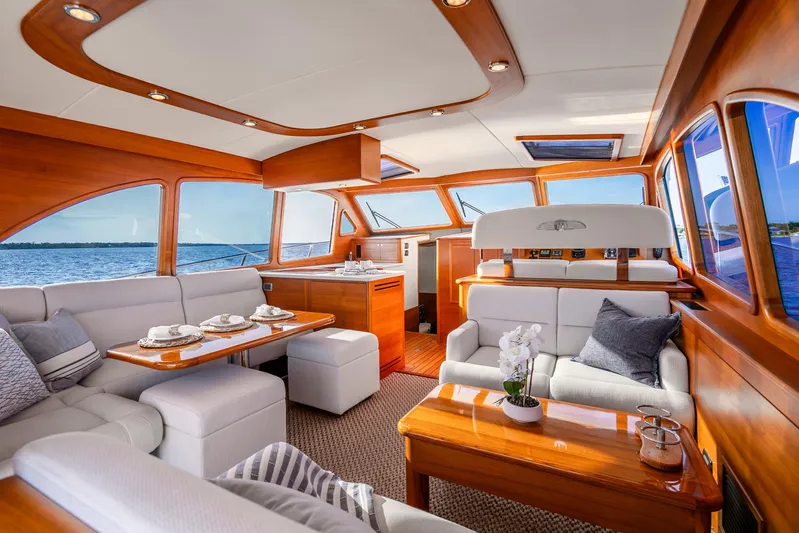 Pitt Stop Yacht Photos Pics Luxurious interior of 2020 Palm Beach Motor Yachts PB55 with elegant wood finish and plush seating.