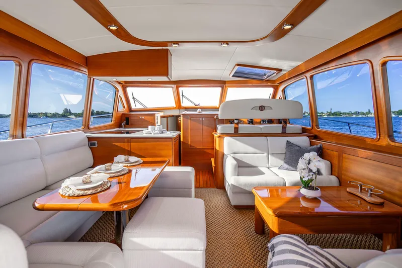 Pitt Stop Yacht Photos Pics Luxurious interior of 2020 Palm Beach Motor Yachts PB55, featuring elegant wood finishes and plush seating.