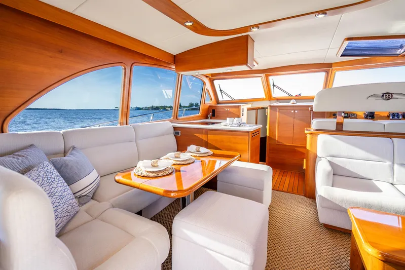 Pitt Stop Yacht Photos Pics Luxurious interior of 2020 Palm Beach Motor Yachts PB55 with elegant wood finish and ocean view.