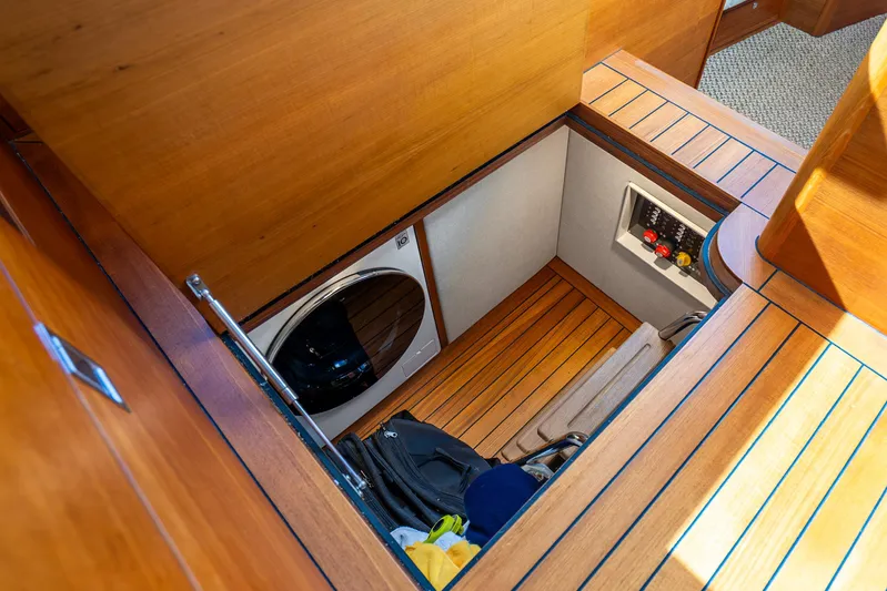 Pitt Stop Yacht Photos Pics 2020 Palm Beach Motor Yachts PB55 interior with laundry area and wooden flooring.