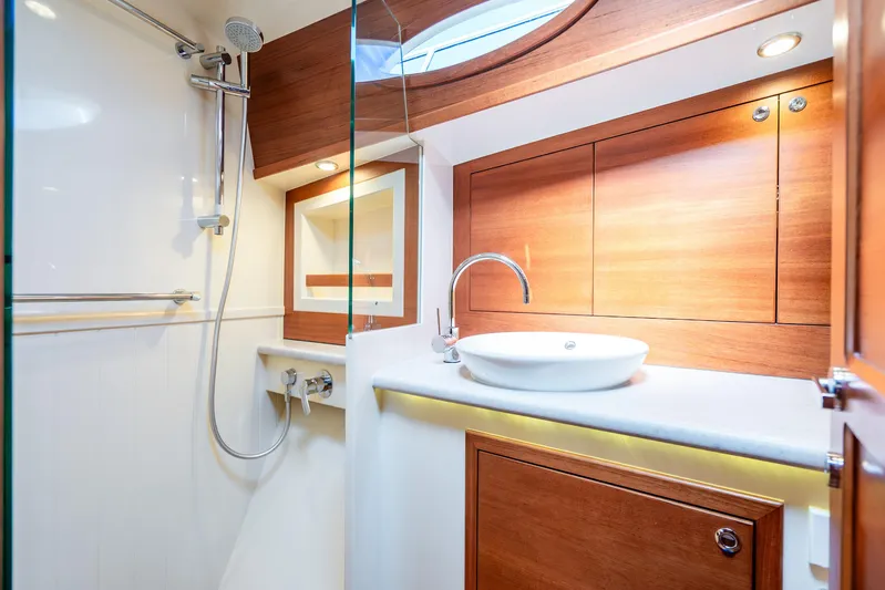 Pitt Stop Yacht Photos Pics Luxurious bathroom in 2020 Palm Beach Motor Yachts PB55, featuring modern fixtures and elegant wood accents.
