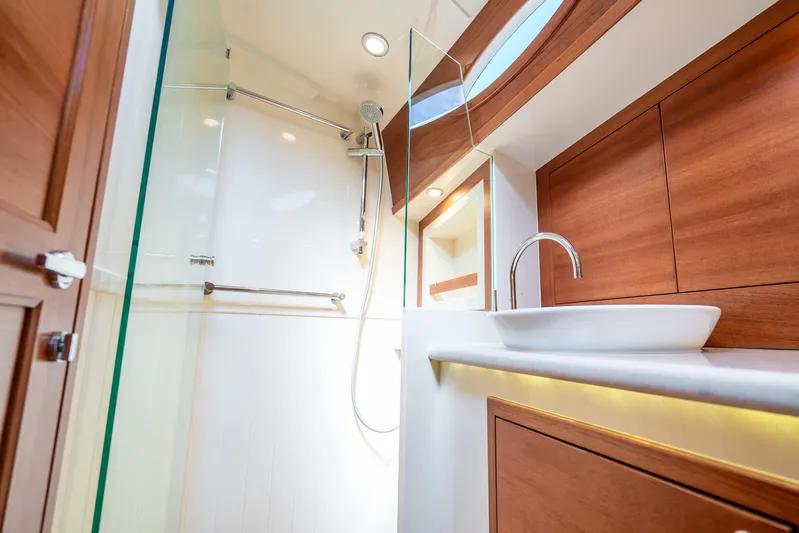 Pitt Stop Yacht Photos Pics Luxurious bathroom interior of 2020 Palm Beach Motor Yachts PB55, featuring modern wood accents.