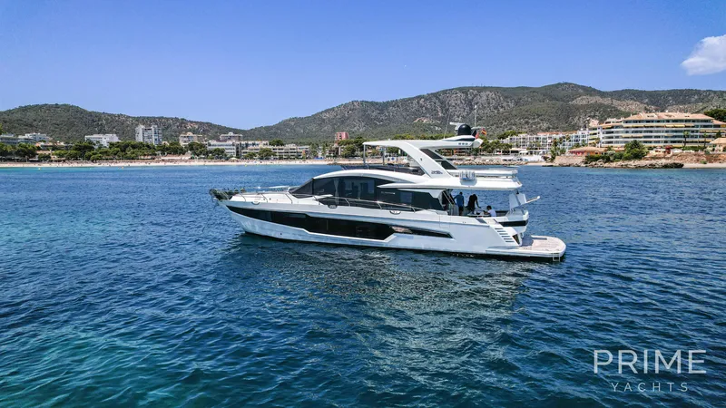  Yacht Photos Pics Luxury 2021 Galeon 680 Fly yacht cruising near scenic coastline.