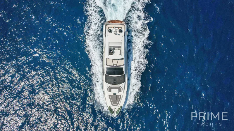  Yacht Photos Pics Aerial view of 2021 Galeon 680 Fly yacht cruising on blue ocean waters.