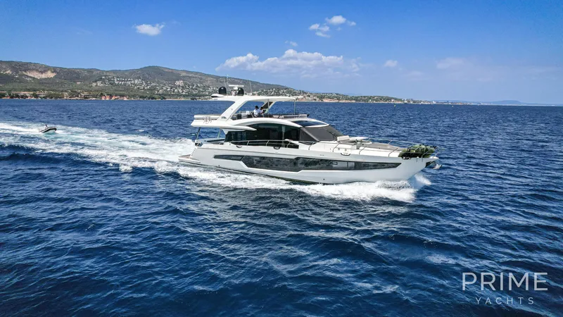  Yacht Photos Pics 2021 Galeon 680 Fly yacht cruising on blue ocean near scenic coastline.