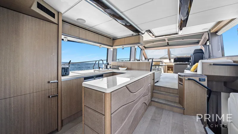  Yacht Photos Pics Luxurious interior of 2021 Galeon 680 Fly yacht with modern kitchen and seating area.