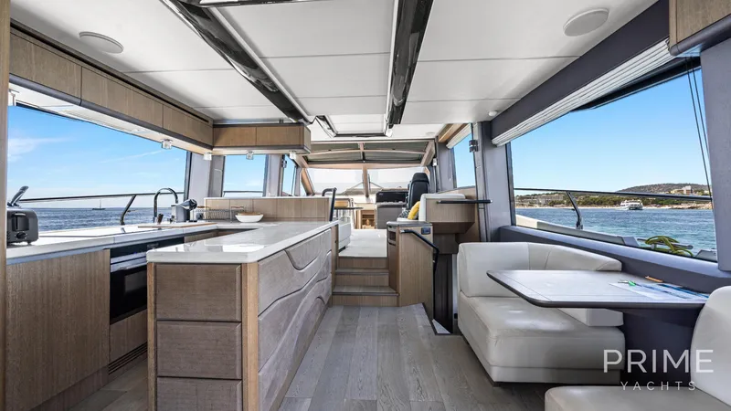  Yacht Photos Pics Luxurious interior of 2021 Galeon 680 Fly yacht with modern kitchen and seating area.