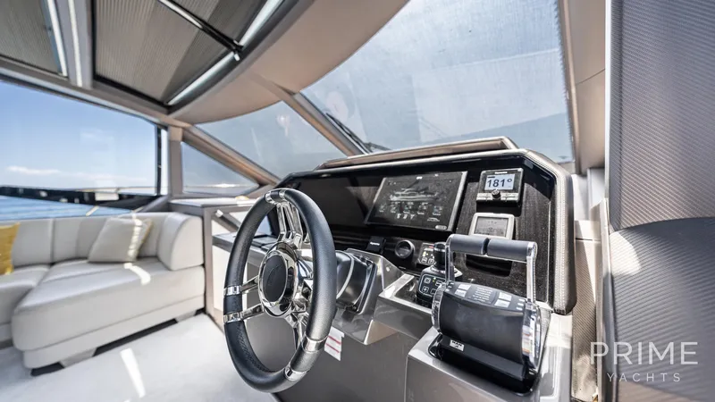  Yacht Photos Pics Luxurious interior of 2021 Galeon 680 Fly yacht cockpit with modern controls and seating.