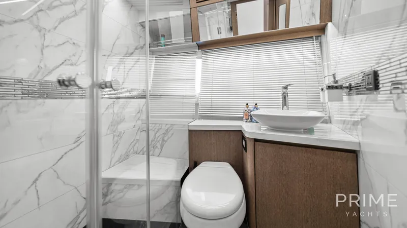  Yacht Photos Pics Luxurious bathroom on 2021 Galeon 680 Fly yacht with marble accents and modern fixtures.