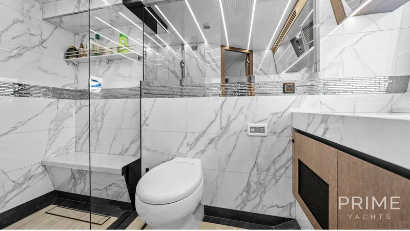  Yacht Photos Pics Luxurious bathroom in 2021 Galeon 680 Fly yacht with marble walls and modern fixtures.