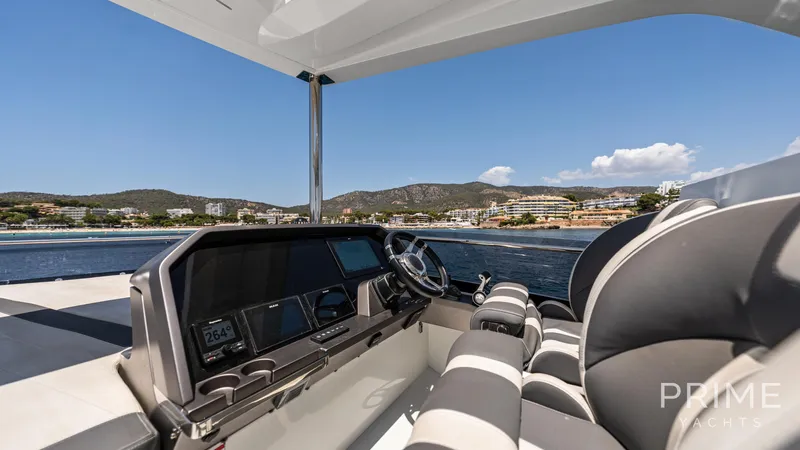  Yacht Photos Pics Luxurious 2021 Galeon 680 Fly yacht cockpit with scenic coastal view.