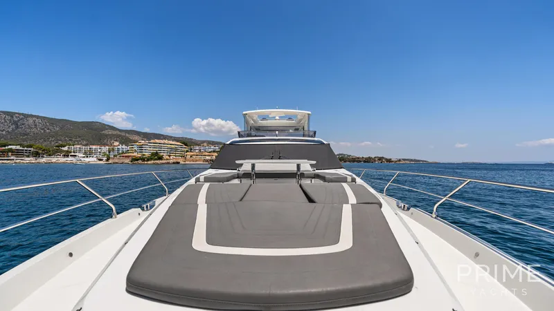  Yacht Photos Pics 2021 Galeon 680 Fly yacht with spacious deck, cruising near scenic coastline.