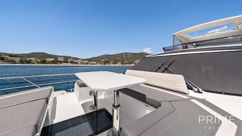  Yacht Photos Pics Luxurious 2021 Galeon 680 Fly yacht deck with seating, table, and scenic ocean view.