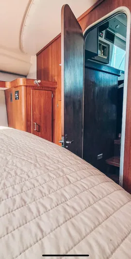  Yacht Photos Pics Interior of 1993 Luhrs 350 Tournament boat with wooden cabinetry and open door.