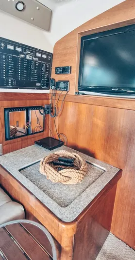  Yacht Photos Pics 1993 Luhrs 350 Tournament cabin interior with control panel and TV.