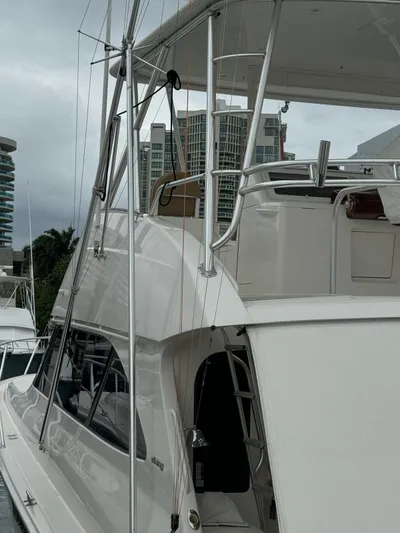  Yacht Photos Pics 2010 Viking 54 Convertible yacht docked at marina with cityscape background.