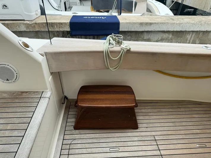  Yacht Photos Pics Viking 54 Convertible 2010 yacht deck with wooden step stool and docked rope.