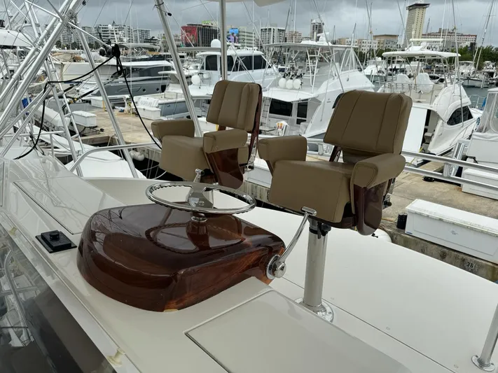  Yacht Photos Pics 2010 Viking 54 Convertible yacht helm station with dual captain's chairs at marina.