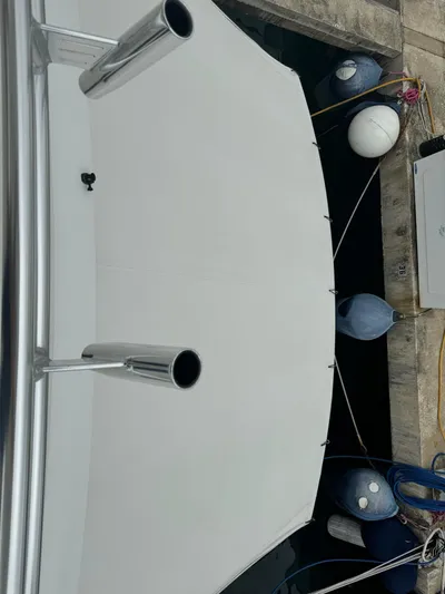  Yacht Photos Pics 2010 Viking 54 Convertible yacht docked with visible exhaust pipes and fenders.