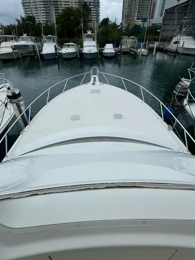  Yacht Photos Pics 2010 Viking 54 Convertible yacht docked in a marina, surrounded by other boats.