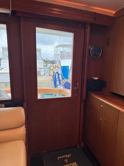  Yacht Photos Pics Interior view of 2010 Viking 54 Convertible yacht with wooden door and window.