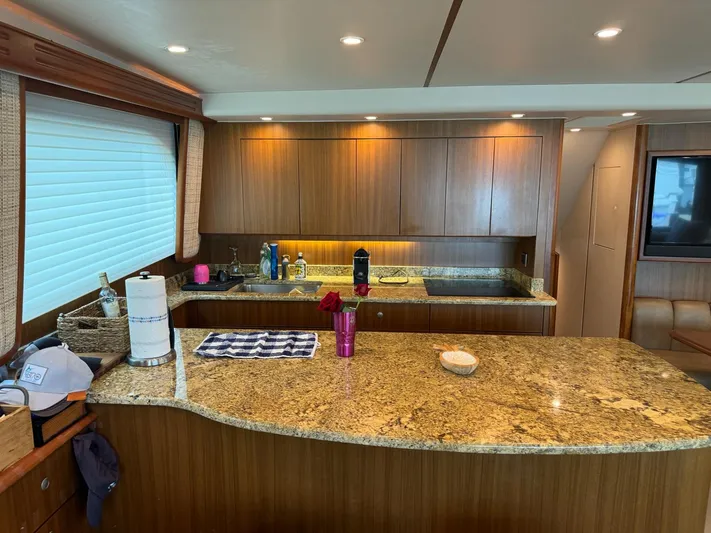  Yacht Photos Pics 2010 Viking 54 Convertible yacht kitchen with granite countertops and wooden cabinetry.