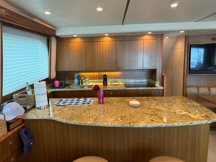  Yacht Photos Pics Luxurious kitchen interior of a 2010 Viking 54 Convertible yacht with granite countertops.