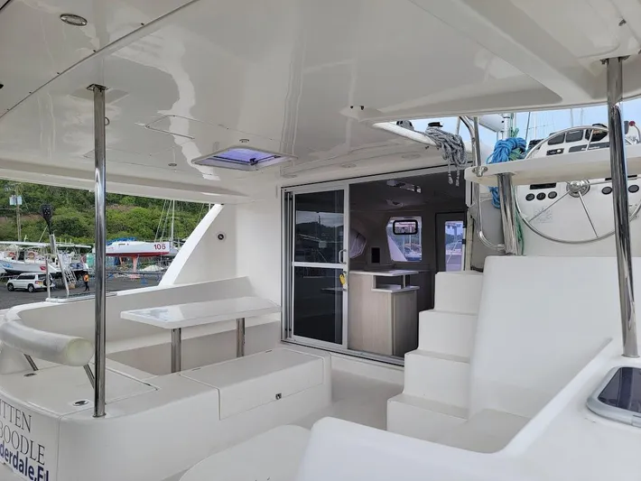 Kitten Caboodle Yacht Photos Pics Spacious deck of 2015 Leopard 44 catamaran with seating and modern interior.