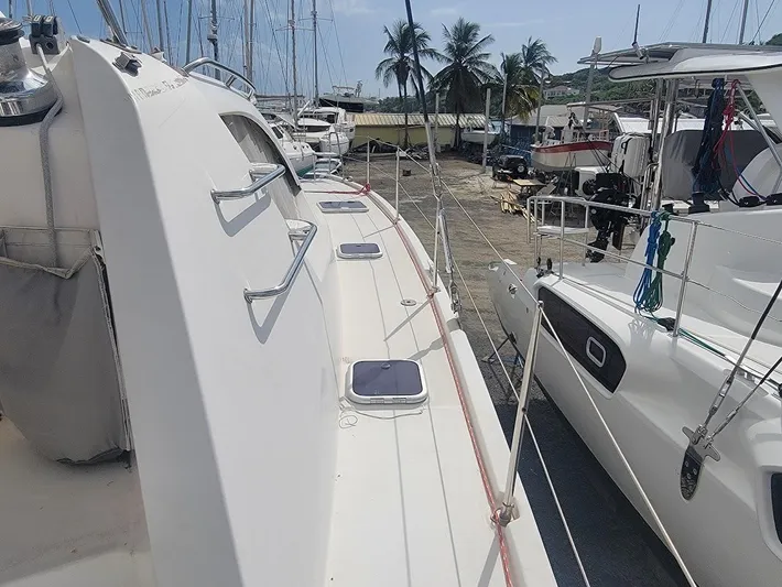 Kitten Caboodle Yacht Photos Pics 2015 Leopard 44 catamaran docked, showcasing sleek design and spacious deck.
