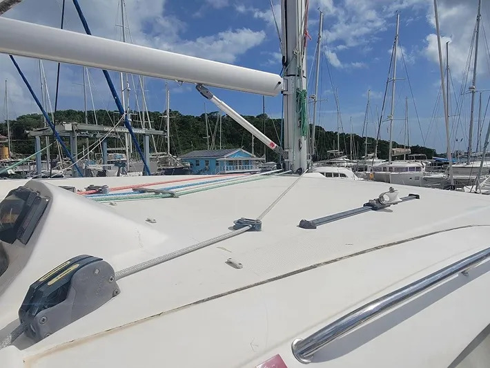 Kitten Caboodle Yacht Photos Pics 2015 Leopard 44 catamaran deck with rigging, docked in a marina under blue skies.