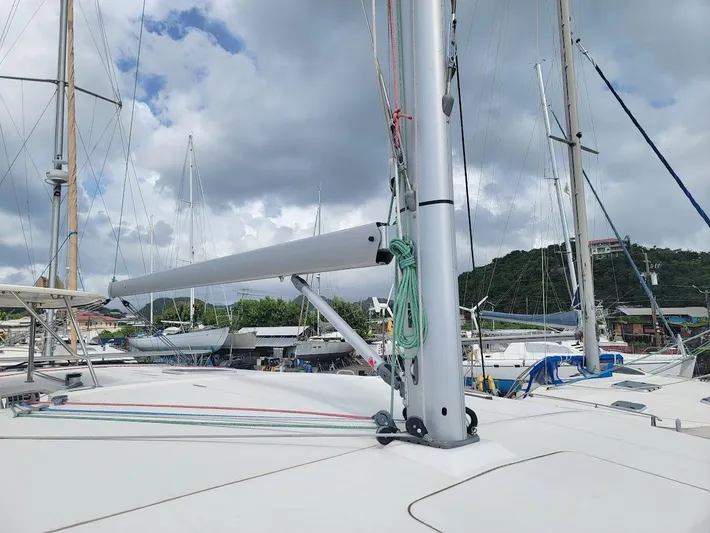 Kitten Caboodle Yacht Photos Pics Sailboat deck view of 2015 Leopard 44, featuring mast and rigging under cloudy sky.