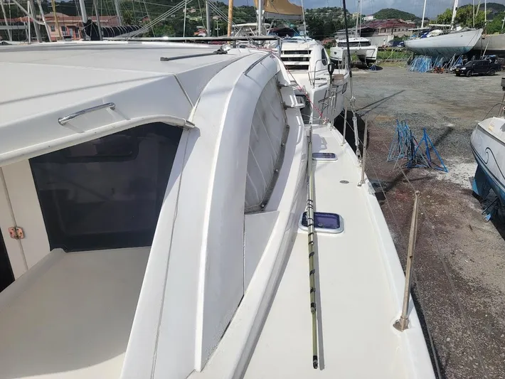 Kitten Caboodle Yacht Photos Pics 2015 Leopard 44 catamaran docked, showcasing sleek design and spacious deck.