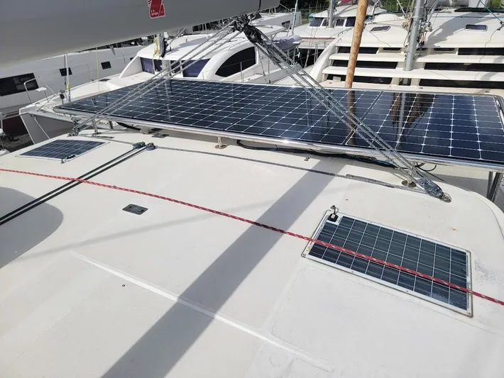 Kitten Caboodle Yacht Photos Pics Solar panels on a 2015 Leopard 44 catamaran deck, docked at a marina.