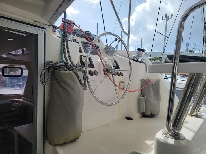 Kitten Caboodle Yacht Photos Pics Sailing yacht cockpit of 2015 Leopard 44 with steering wheel and ropes.